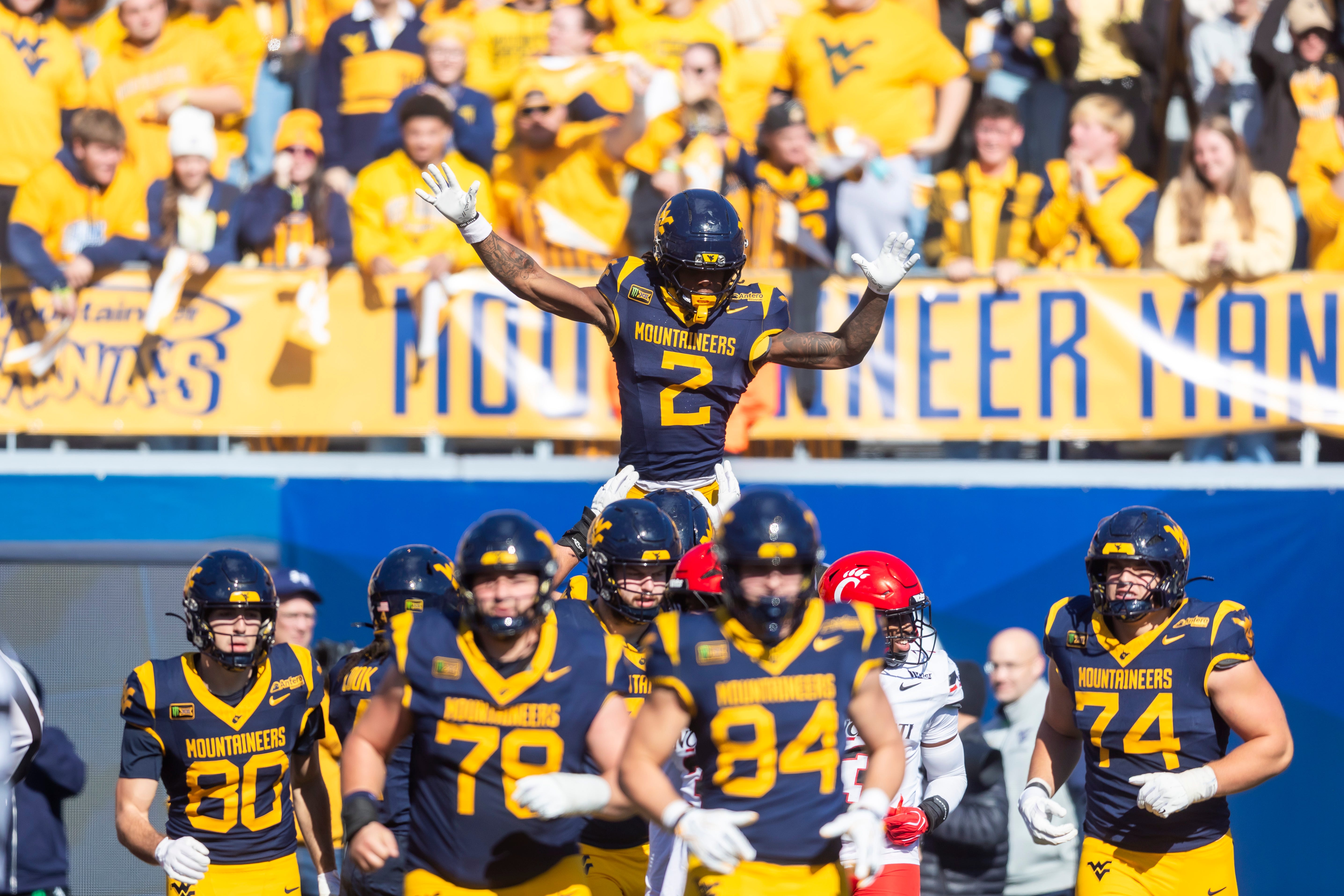 Oct 17, 2026; Morgantown, West Virginia, USA;  West Virginia Mountaineers wide receiver DJ Epps (2) celebrates with teammates after scoring a touchdown during the fourth quarter against the Cincinnati Bearcats at Milan Puskar Stadium.  Mandatory Credit: Ben Queen-Imagn Images