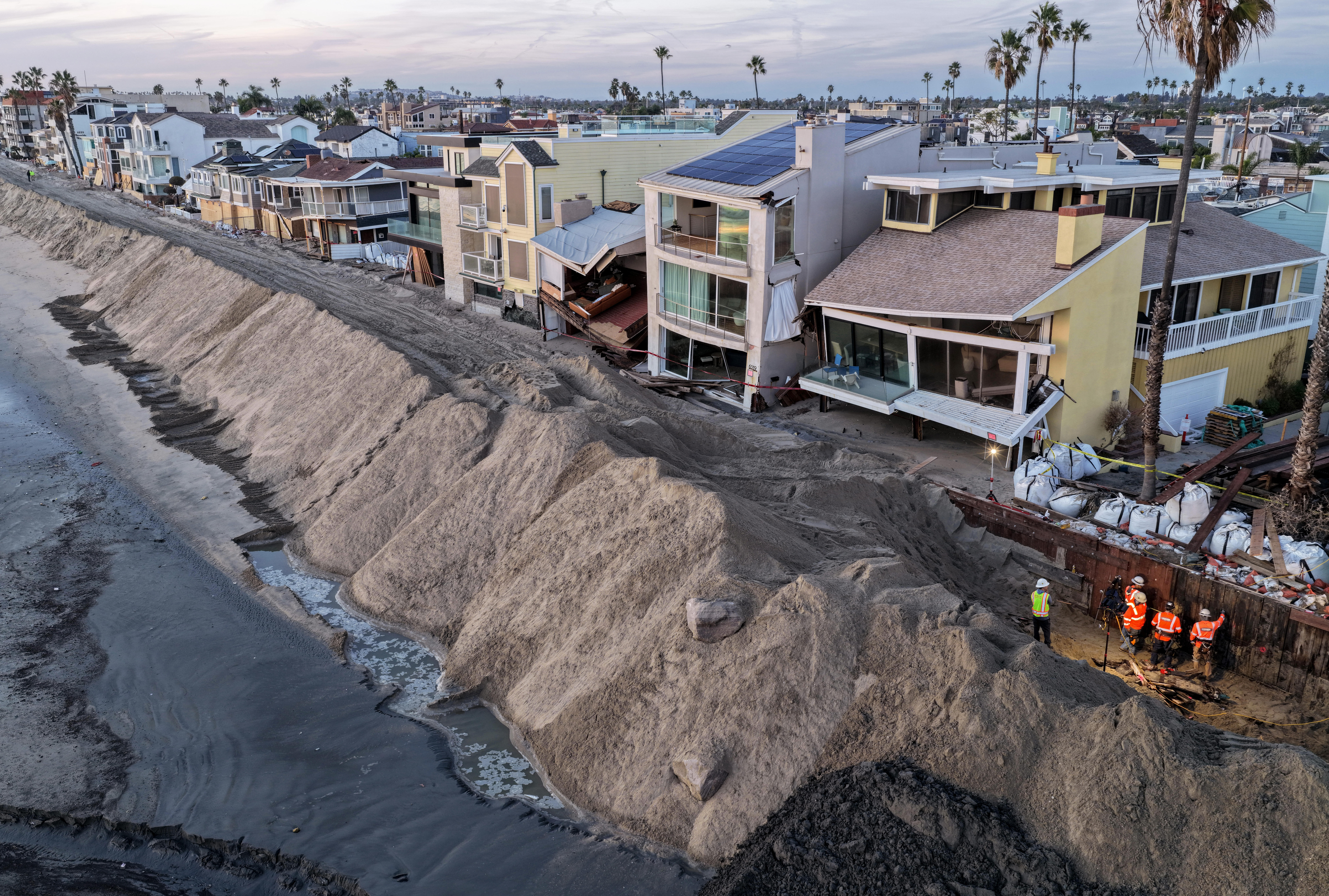 Photos show record-breaking tides flooding homes, roads in California