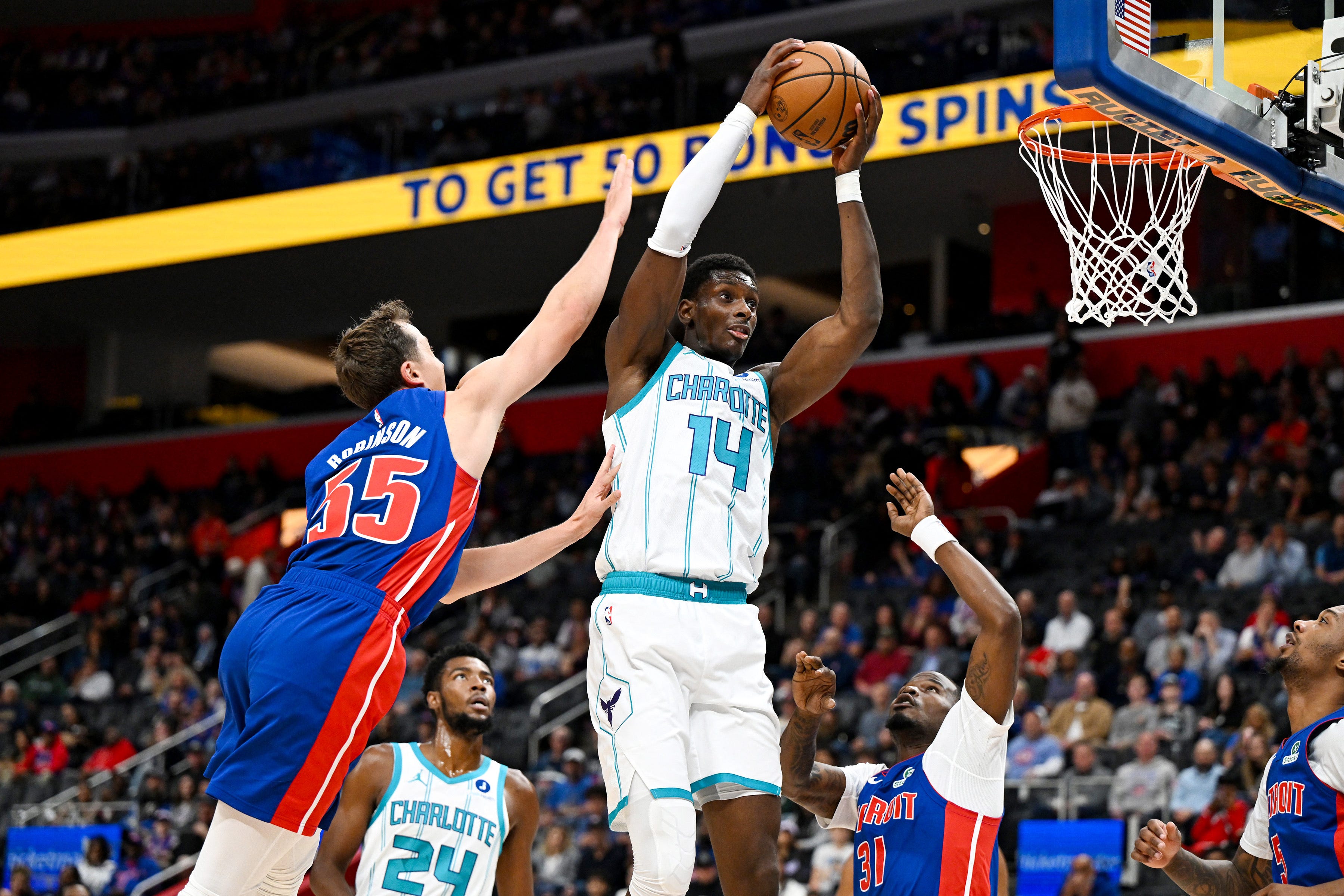Oct 28, 2026; Detroit, Michigan, USA;  Charlotte Hornets forward Moussa Diabate (14) pulls down an offensive rebound between Detroit Pistons forward Duncan Robinson (55) and guard Javonte Green (31) in the first quarter at Little Caesars Arena.  Mandatory Credit: Lon Horwedel-Imagn Images