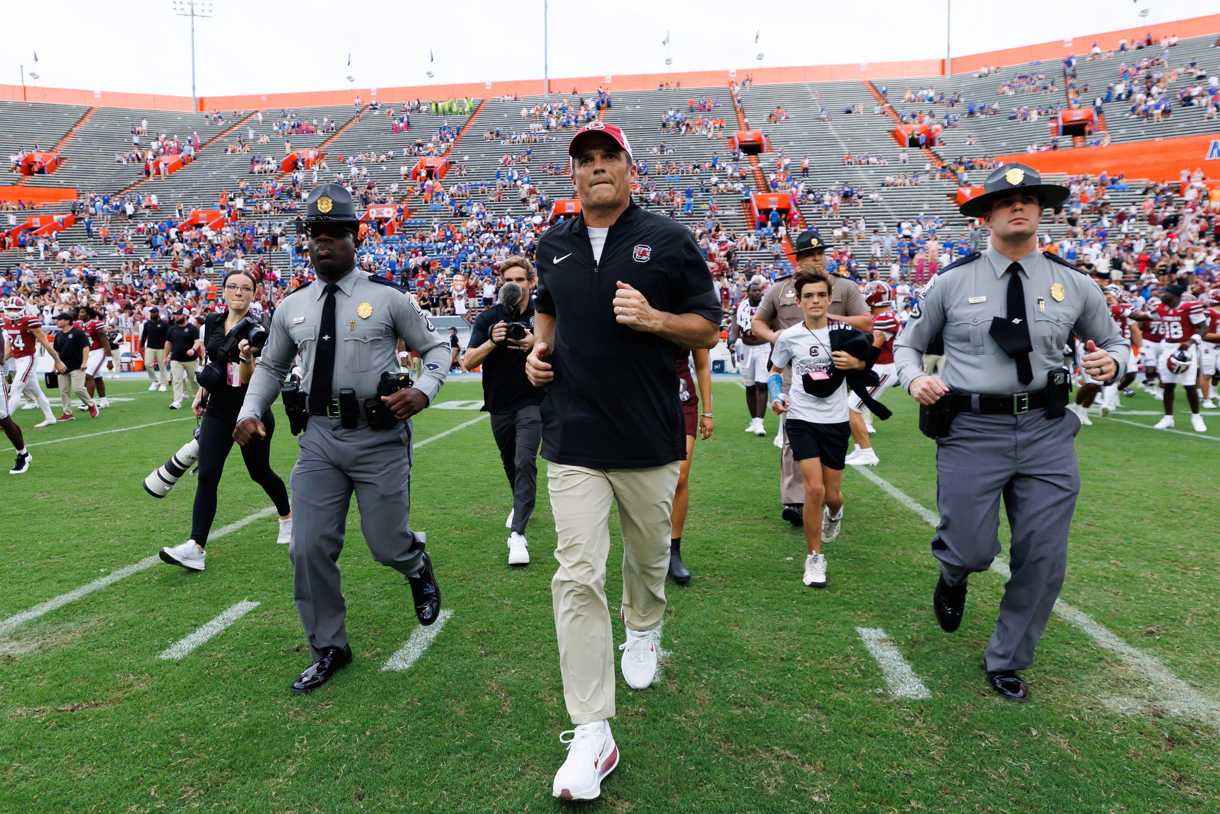 South Carolina football coach Shane Beamer runs to midfield after his team's defeat of Florida at Ben Hill Griffin Stadium.